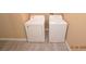 Functional laundry room with a white washer and dryer set on wood-look flooring at 41 Rosa Rosales Ct, North Las Vegas, NV 89031