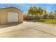 Spacious backyard featuring a shed, concrete, landscaped yard, and mature trees on a sunny day at 4795 W Maulding Ave, Las Vegas, NV 89139