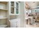 Bright bathroom featuring ample storage, a pedestal sink, and decorative tile at 4795 W Maulding Ave, Las Vegas, NV 89139