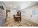 Dining room with travertine floors and brick accent wall at 4795 W Maulding Ave, Las Vegas, NV 89139