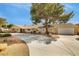 Inviting single-level home with mature trees, rock landscaping, and a wide driveway leading to the garage at 4795 W Maulding Ave, Las Vegas, NV 89139