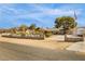 Exterior of a cozy ranch-style home with a block fence, ample parking, and mature landscaping at 4795 W Maulding Ave, Las Vegas, NV 89139