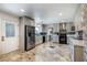 Updated kitchen featuring quartz counters, gray cabinetry, and stainless steel appliances at 4795 W Maulding Ave, Las Vegas, NV 89139