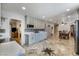 Spacious kitchen features travertine floors, stylish cabinetry, and a view into the living and dining areas at 4795 W Maulding Ave, Las Vegas, NV 89139