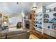 Comfortable living area with a brick fireplace, built-in shelving, and inviting seating arrangement at 4795 W Maulding Ave, Las Vegas, NV 89139
