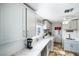 Well organized mud room area featuring white cabinets, sink, laundry, and stylish countertops at 4795 W Maulding Ave, Las Vegas, NV 89139