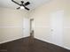 A bedroom with hardwood floors, ceiling fan, and two doors at 5330 E Charleston Blvd # 116, Las Vegas, NV 89142