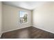 Bright bedroom with hardwood floors and a window overlooking the neighborhood at 5330 E Charleston Blvd # 116, Las Vegas, NV 89142