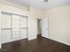 This bedroom boasts stylish hardwood floors and closet with shelving unit and rods at 5330 E Charleston Blvd # 116, Las Vegas, NV 89142