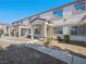 Charming townhome with well-kept gravel yard, covered entryway, and view of multi-pane windows at 5330 E Charleston Blvd # 116, Las Vegas, NV 89142