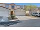 Well-maintained townhome featuring a private front entrance and an attached one-car garage at 5330 E Charleston Blvd # 116, Las Vegas, NV 89142