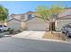 Charming townhome showcasing a one-car garage, complemented by manicured landscaping at 5330 E Charleston Blvd # 116, Las Vegas, NV 89142