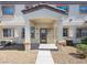 Charming townhome with desert landscaping, covered entryway, and view of multi-pane windows at 5330 E Charleston Blvd # 116, Las Vegas, NV 89142