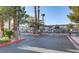 Gated entrance to the community with palm trees and desert landscaping at 5330 E Charleston Blvd # 116, Las Vegas, NV 89142