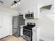Galley kitchen with stainless steel appliances and modern fixtures at 5330 E Charleston Blvd # 116, Las Vegas, NV 89142