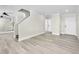 Bright living room with modern gray floors, white trim, and staircase with half wall at 5330 E Charleston Blvd # 116, Las Vegas, NV 89142