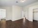 Bright main bedroom featuring ensuite bathroom, walk-in closet, and dark wood floors at 5330 E Charleston Blvd # 116, Las Vegas, NV 89142