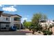 Apartment building featuring a carport and a blue car out front on a bright, sunny day at 5650 E Sahara Ave # 2041, Las Vegas, NV 89142