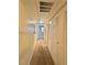 Hallway with neutral carpet and white walls leads to a bright and inviting space at 5650 E Sahara Ave # 2041, Las Vegas, NV 89142