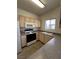 Well-lit kitchen equipped with a gas range, microwave, and double sink at 5650 E Sahara Ave # 2041, Las Vegas, NV 89142
