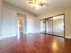 Bright bedroom with hardwood floors, ceiling fan, and mirror closet doors at 6250 W Flamingo Rd # 11, Las Vegas, NV 89103