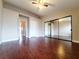 The spacious bedroom has a mirrored closet and wood floors at 6250 W Flamingo Rd # 11, Las Vegas, NV 89103