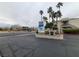 Community entrance sign showcasing the property's name, set against a backdrop of palm trees and landscaping at 6250 W Flamingo Rd # 11, Las Vegas, NV 89103