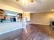 Open living room and kitchen with hardwood floors, tile backsplash, and stainless steel appliances at 6250 W Flamingo Rd # 11, Las Vegas, NV 89103