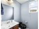 Neat bathroom with a modern vanity, black toilet, and a window providing natural light at 6429 Pronghorn Ridge Ave, Las Vegas, NV 89122