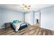 Light and airy bedroom with wood-look floors and ceiling fan at 6429 Pronghorn Ridge Ave, Las Vegas, NV 89122
