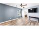 Large bedroom with ensuite bath, ceiling fan, and wood-look floors at 6429 Pronghorn Ridge Ave, Las Vegas, NV 89122