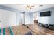Bedroom with wood-look floors and large TV at 6429 Pronghorn Ridge Ave, Las Vegas, NV 89122