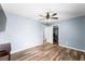 Light filled bedroom with ensuite bath, ceiling fan, and wood-look floors at 6429 Pronghorn Ridge Ave, Las Vegas, NV 89122
