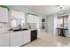 A well lit kitchen featuring white cabinetry, modern appliances, and a double basin sink at 6429 Pronghorn Ridge Ave, Las Vegas, NV 89122