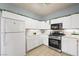 Bright kitchen featuring white cabinets, stainless steel appliances, and tiled floor at 6429 Pronghorn Ridge Ave, Las Vegas, NV 89122