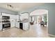 Bright kitchen featuring white cabinets, stainless steel appliances, open to adjacent dining area at 6429 Pronghorn Ridge Ave, Las Vegas, NV 89122