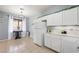 Bright eat-in kitchen with white cabinets and stainless steel appliances, next to dining area at 6429 Pronghorn Ridge Ave, Las Vegas, NV 89122