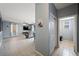 Open-concept living room with modern flooring that flows into dining area and featuring a convenient half bath at 6429 Pronghorn Ridge Ave, Las Vegas, NV 89122