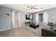 Comfortable living area features a ceiling fan, TV, and plush rug for a relaxing and inviting atmosphere at 6429 Pronghorn Ridge Ave, Las Vegas, NV 89122