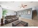 Spacious living area with ceiling fan, dining space, and staircase, offering ample room for comfortable living at 6429 Pronghorn Ridge Ave, Las Vegas, NV 89122