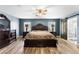 Elegantly furnished main bedroom with wood-look floors, ceiling fan, and ample space for furniture and relaxation at 6429 Pronghorn Ridge Ave, Las Vegas, NV 89122