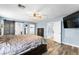 Comfortable main bedroom with wood flooring, ceiling fan, and sliding barn door closet at 6429 Pronghorn Ridge Ave, Las Vegas, NV 89122