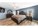 Spacious main bedroom featuring wood floors, ceiling fan, and a king-sized bed at 6429 Pronghorn Ridge Ave, Las Vegas, NV 89122