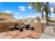 Cozy outdoor patio with brick walls, lounge chairs and coffee table at 6429 Pronghorn Ridge Ave, Las Vegas, NV 89122