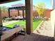 Beautiful backyard features a pergola, artificial grass, and tasteful landscaping at 6507 Dove Point Pl, Las Vegas, NV 89130