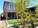 This backyard offers a relaxing outdoor space with manicured turf, trees, and patio at 6507 Dove Point Pl, Las Vegas, NV 89130