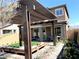 Charming backyard features a pergola covered patio, artificial turf, and desert landscaping at 6507 Dove Point Pl, Las Vegas, NV 89130