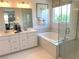 Luxurious bathroom with double sinks, a soaking tub, and a glass-enclosed shower at 6507 Dove Point Pl, Las Vegas, NV 89130