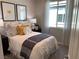 Cozy bedroom with decorative pillows, bedside tables, and natural light from the window at 6507 Dove Point Pl, Las Vegas, NV 89130