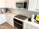 Modern kitchen with stainless steel appliances including a built-in oven, gas cooktop, and microwave at 6507 Dove Point Pl, Las Vegas, NV 89130